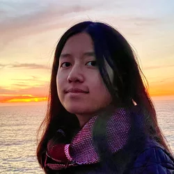 Amy Tran standing in front of a body of water